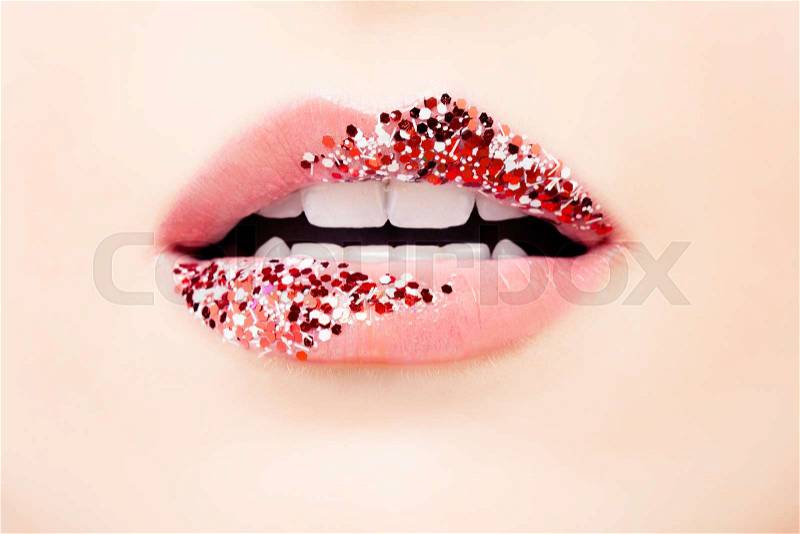 Pastel pink color lips with glitter and tint. Matte pink tint and red glossy glitter make-up, stock photo