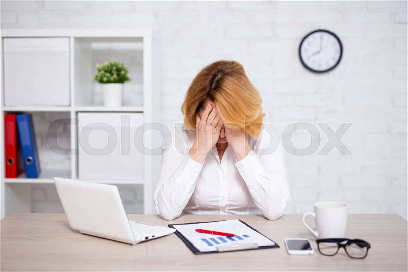 Depression concept - stressed mature business woman sitting in office, stock photo