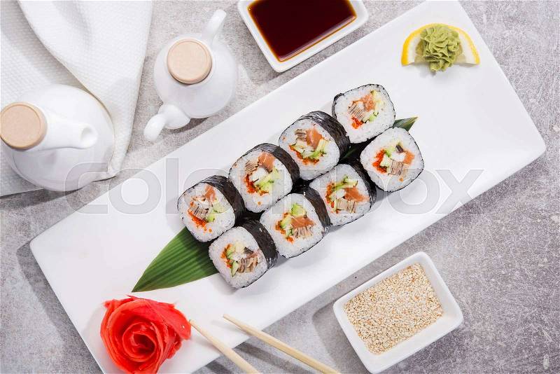 Tasty japan sushi with red ginger, soy sauce and sesame on stone table. top view. flat lay, stock photo
