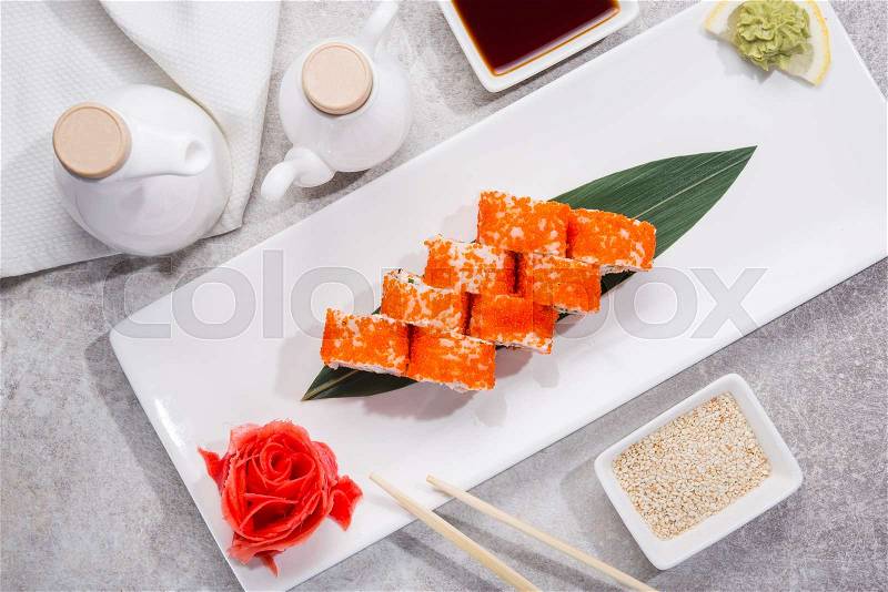 Tasty japan sushi with red ginger, soy sauce and sesame on stone table. top view. flat lay, stock photo