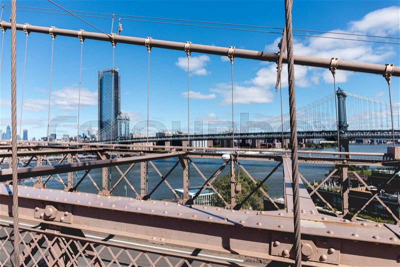Urban scene of manhattan from brooklyn bridge in new york, usa, stock photo