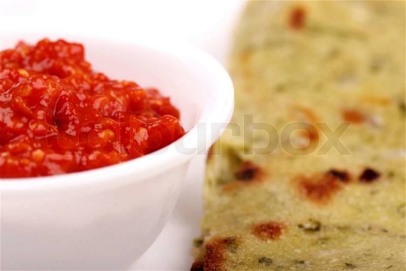Spicy chili chutney with indian bread, stock photo