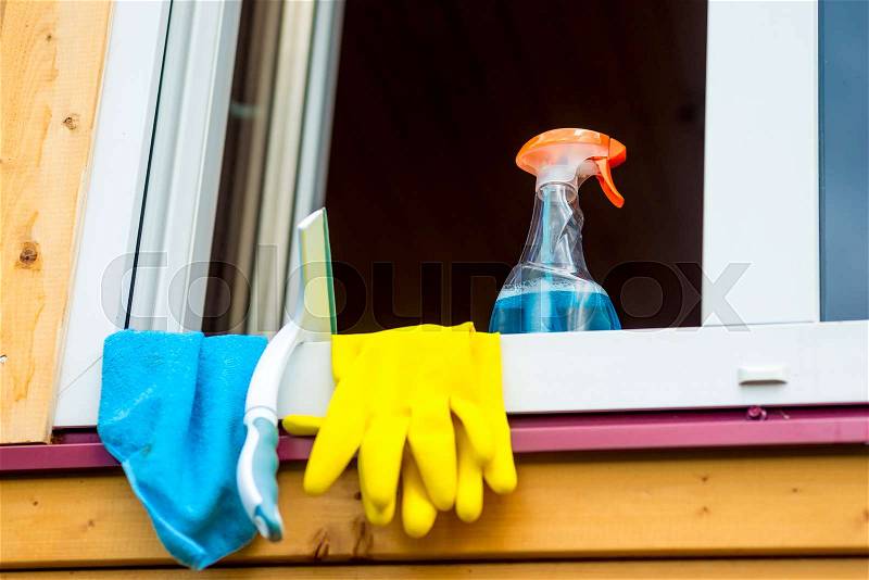 Window cleaning tools on window sill close up , stock photo
