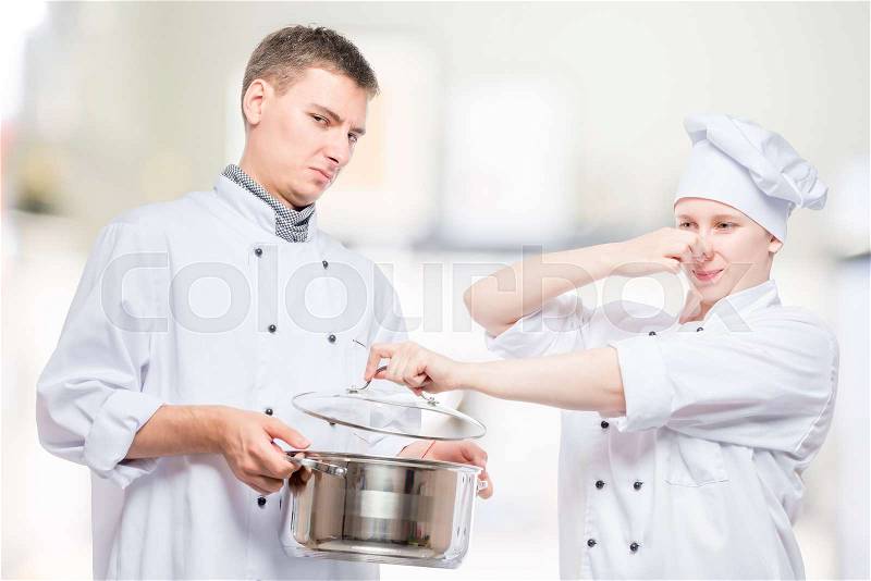 Concept photo - cooks and foul soup in a pan, shooting on the background of the kitchen, stock photo