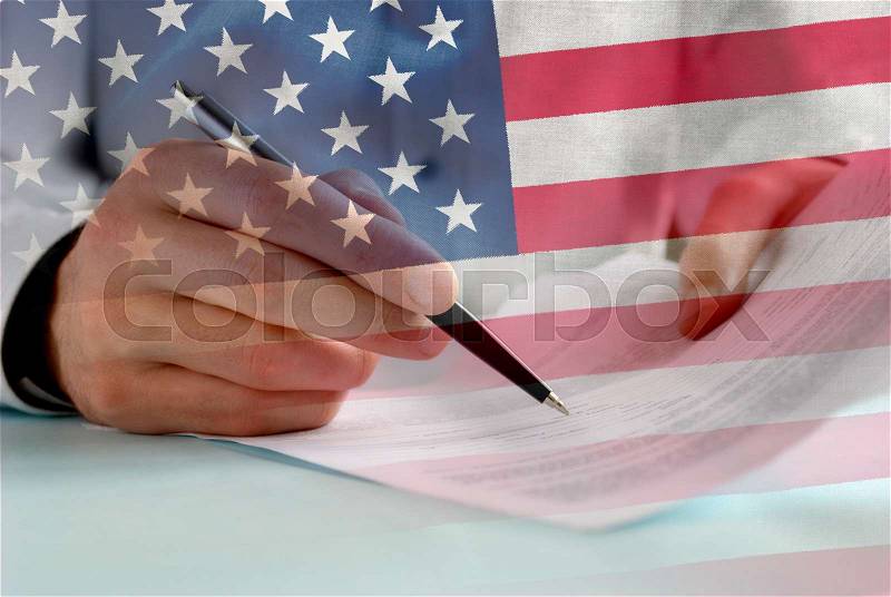 Businessman signing papers with US flag overlay in a concept of negotiation, agreement and breaking the shutdown in the united States of America, stock photo