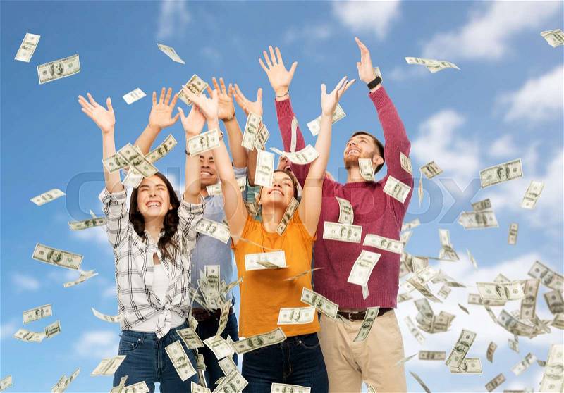 Finance, wealth and people concept - group of happy friends picking money falling from up above over blue sky and clouds background, stock photo
