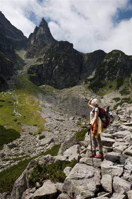 Backpacker girl exploring the mountains, stock photo