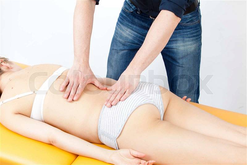 Massage therapist giving a massage female receiving professional massage Series, stock photo