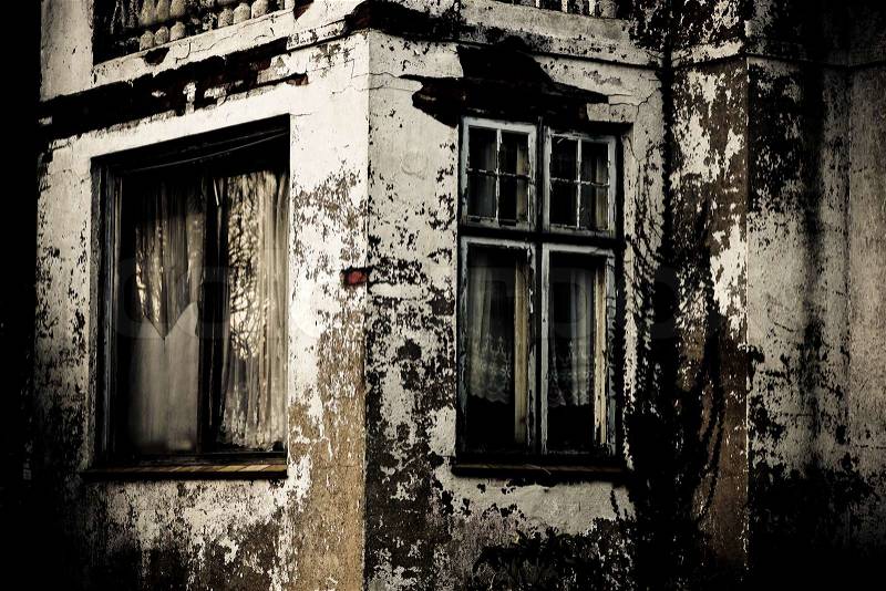 Spooky grunge house with torn windows, stock photo