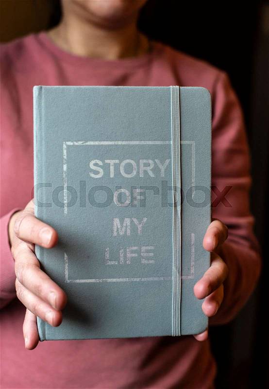Woman hold notebook. Book notes for the Story of my life. Personal memoirs notes concept. Hands hold book, stock photo