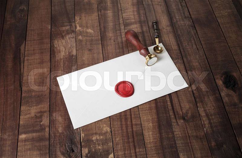 Vintage letter envelope with red wax seal, stamp and spoon on wood table background. Mock-up for your design, stock photo