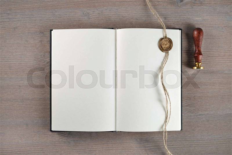 Vintage blank book, sealing wax, stamp and rope on wooden background. Flat lay, stock photo
