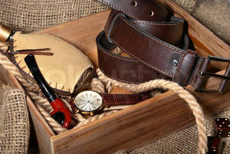 Watch, leather belt and wallet, bottle with cologne on wooden background. Stylish mens business accessories, stock photo