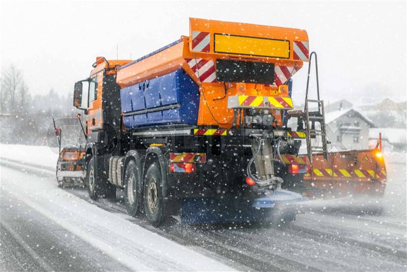 Snowplow truck removing dirty snow from city street or highway during heavy snowfalls. Traffic road situation. Weather forecast for drivers. Seasonal road ..., stock photo
