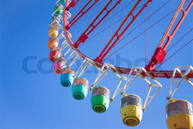 Amazing colorful ferris wheel in amusement park with sunshine blue sky in the morning with copy space, can be used as optimistic or start new day with happiness ..., stock photo