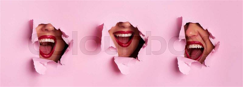 Different type of crying emotional woman screaming through hole in pink background. Emotional, young face. Human emotions, facial expression concept. Trendy colors, stock photo