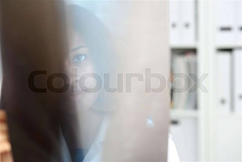 Female black doctor hold in arm and look at xray photography discussing it with female patient portrait. Bone disease exam medic assistance cancer test healthy ..., stock photo