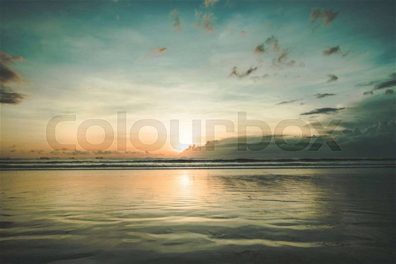 The sunset over the calm water surface. Picturesque twilight Asian landscape. The fall sun in the colorful sky over the ocean body. The peacefulness. Ideal place for ..., stock photo