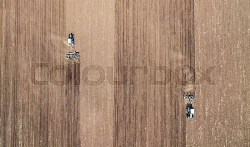 Farm machinery on the field. Agricultural landscape from the air, stock photo