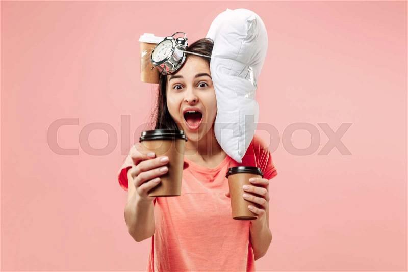 Tired happy woman drinking coffee at home or office having too much work. Bored businesswoman with pillow and coffee cups. The busy, boring, worried, be late, ..., stock photo