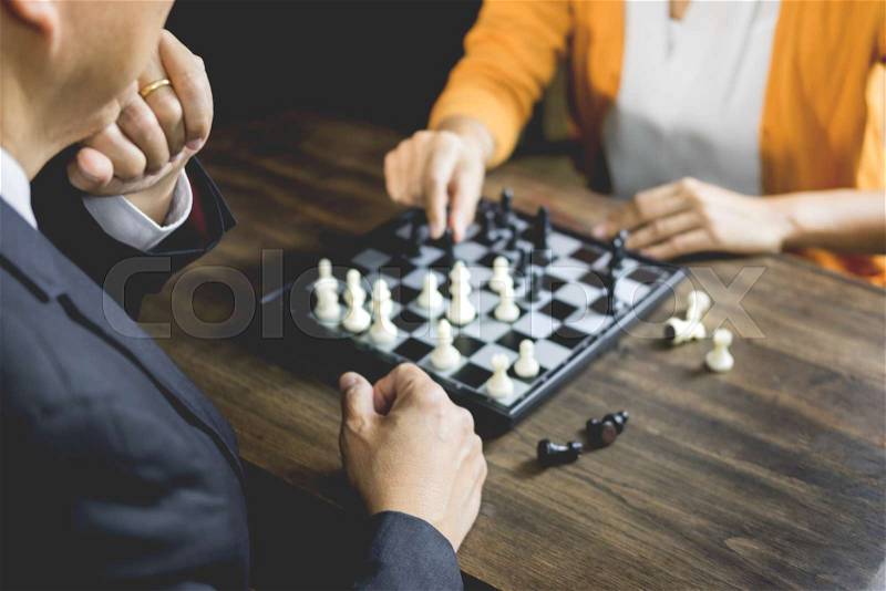 Hand of businessman moving chess figure in competition board game for development analysis, strategy idea management or leadership concept, stock photo