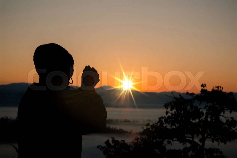 Silhouette of christian man hand praying,spirituality and religion,man praying to god. Christianity concept, stock photo