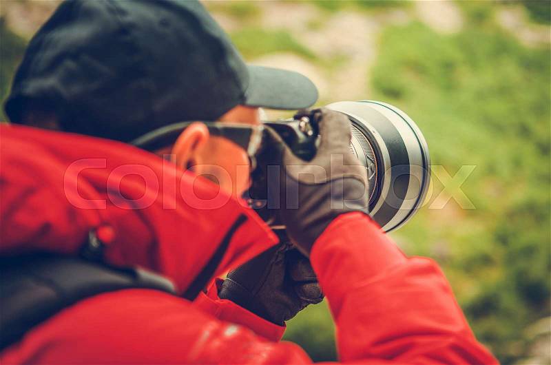 Telephoto Nature Photography. Caucasian Professional Photographer with Large Super Telephoto Lens Attached to Digital Camera, stock photo