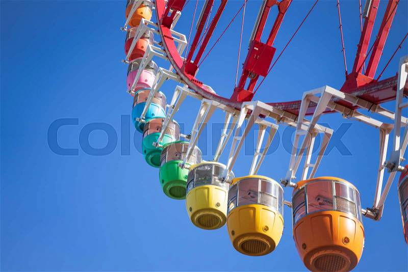 Amazing colorful ferris wheel in amusement park with sunshine blue sky in the morning with copy space, can be used as optimistic or start new day with happiness ..., stock photo