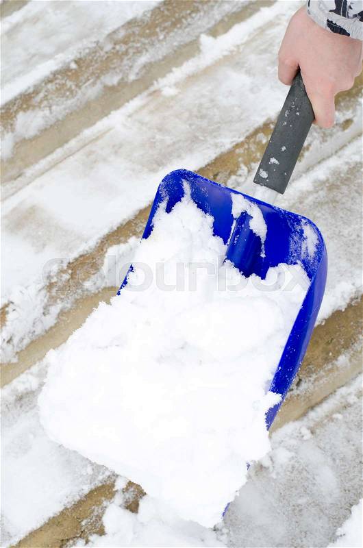 Cleaning of snow. Clearing in winter time by means of shovel. Studio Photo, stock photo