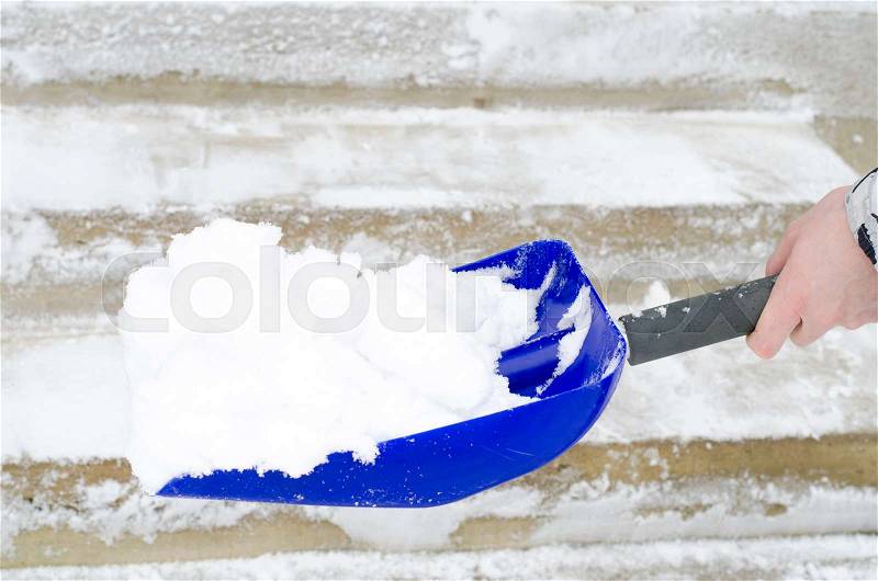 Cleaning of snow. Clearing in winter time by means of shovel. Studio Photo, stock photo