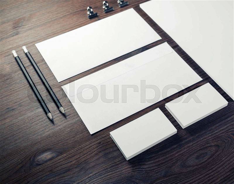 Blank branding mock-up. Blank envelopes, business cards and pencils on wooden background, stock photo
