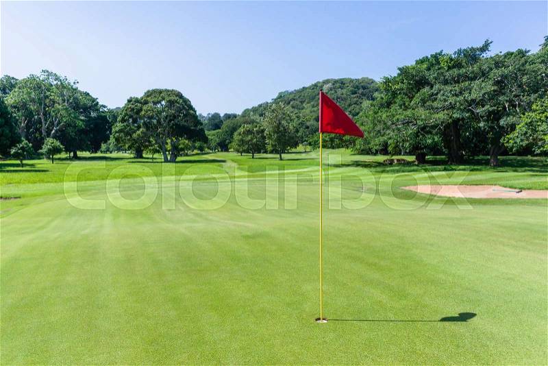 Golf course hole flagstick green scenic summer coastal course, stock photo