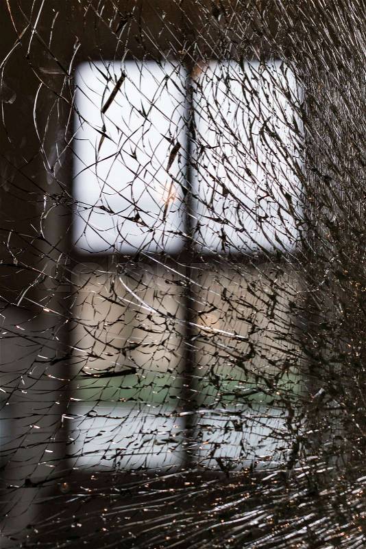 Background of broken transparent window glass close-up, stock photo