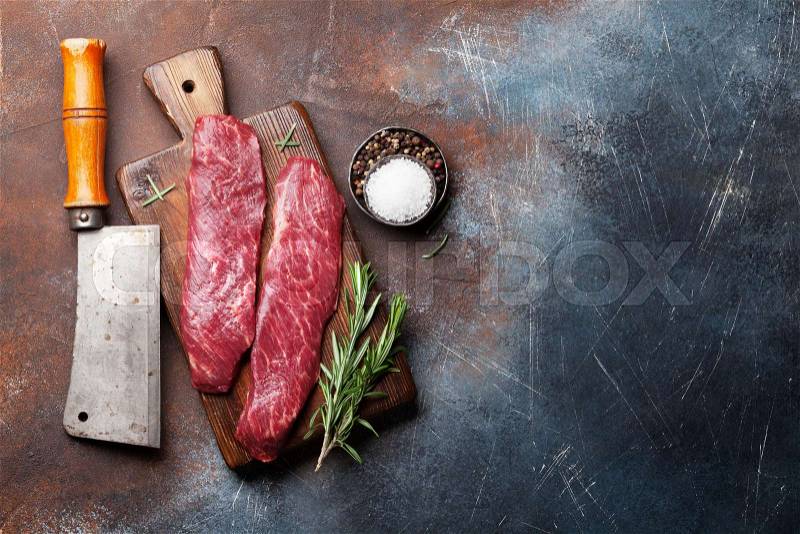 Raw top blade or denver steak cooking on cutting board cooking. Top view with copy space, stock photo