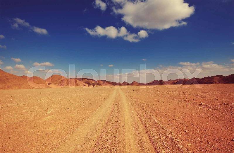 Safari and extreme travel in Africa. Drought mountain landscape with dust off road in offroad car expedition, stock photo