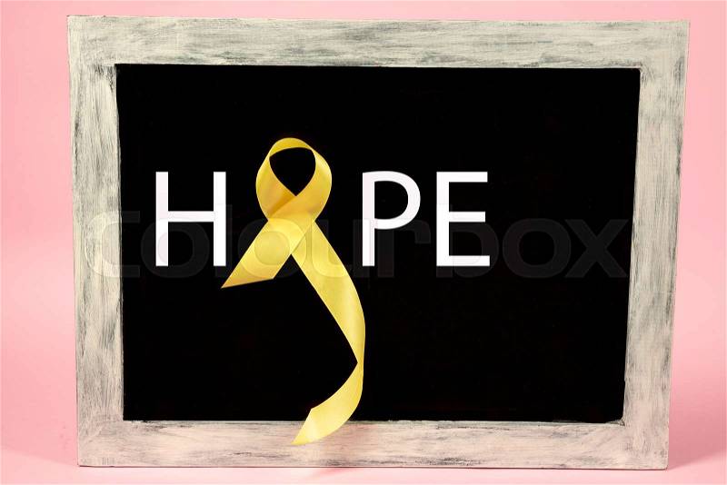 Yellow ribbon symbolic color for Sarcoma Bone cancer awareness and suicide prevention on aged wooden advertising board. The cancer, health, help, care, support, ..., stock photo