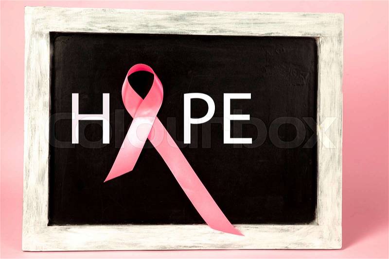 The text world cancer day and a pink ribbon on a on advertising board background. The cancer, health, breast, awareness, campaign, disease, help, care, support, ..., stock photo