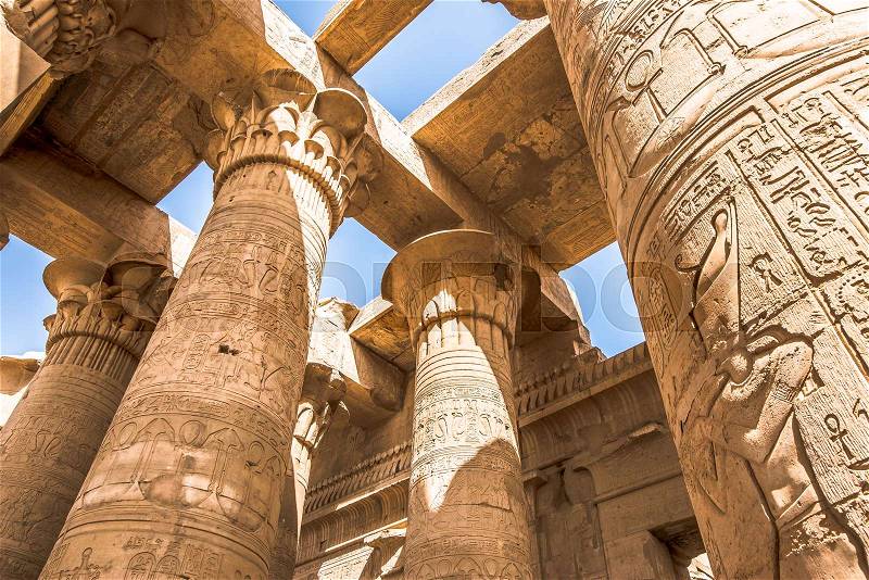 Pillars at the temple of Kom Ombo, decorated with hieroglyphics. The blue sky is seen through the ceiling, Egypt, October 23, 2018, stock photo