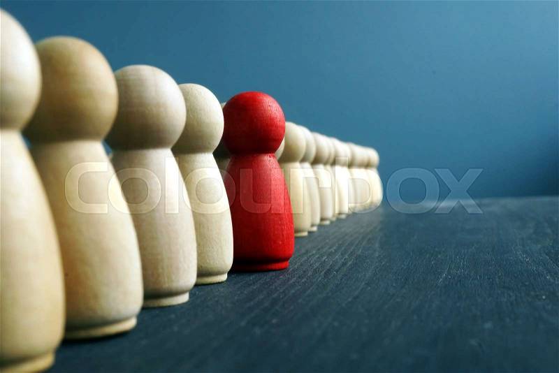 Leadership development. Line of wooden figurines with red one, stock photo