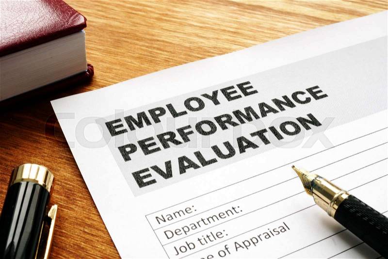Employee performance evaluation form on a desk, stock photo