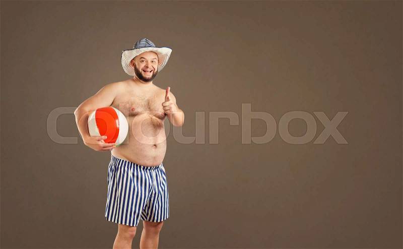 The fat funny man with a beard in the resort on the background space for text, stock photo