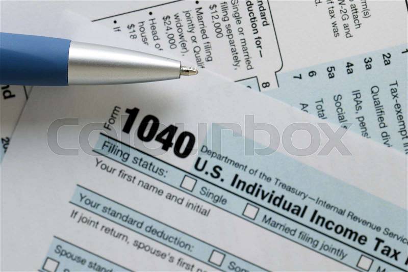 United States federal income tax return IRS 1040 document with blue pen, stock photo