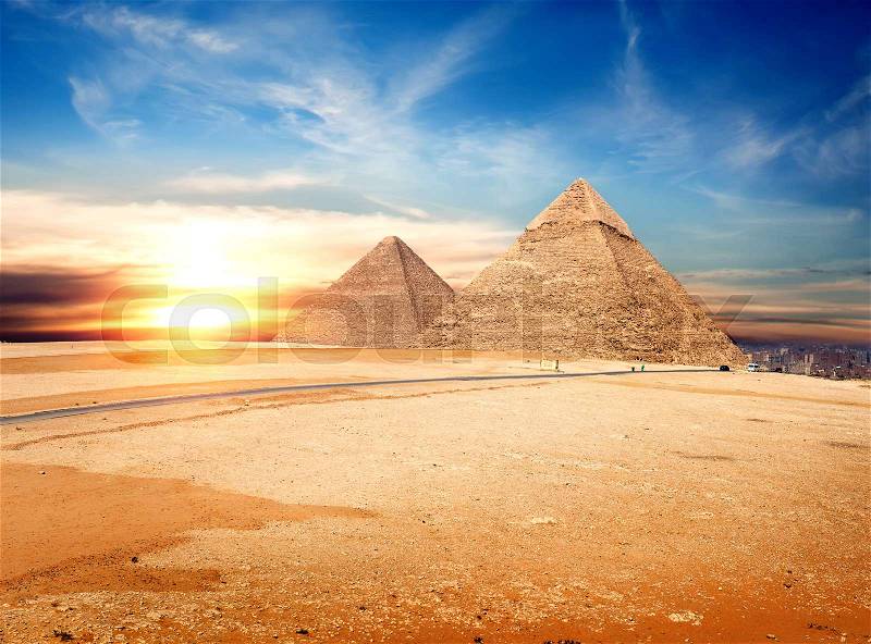 Egyptian pyramids in the Giza desert at sunset, stock photo