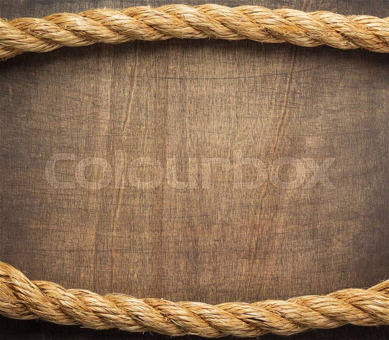 Ship rope at wooden background surface, stock photo