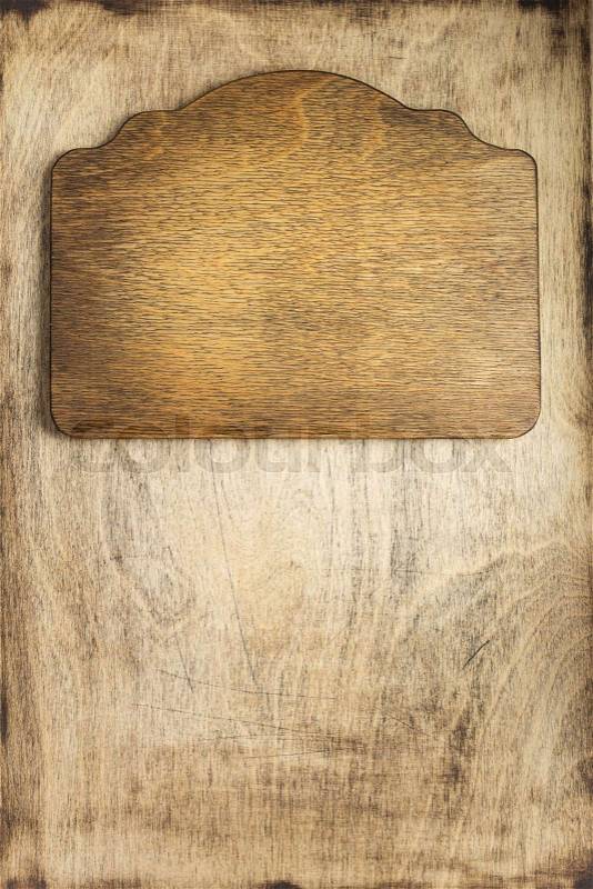 Retro sign board at dark plywood wooden background texture, stock photo
