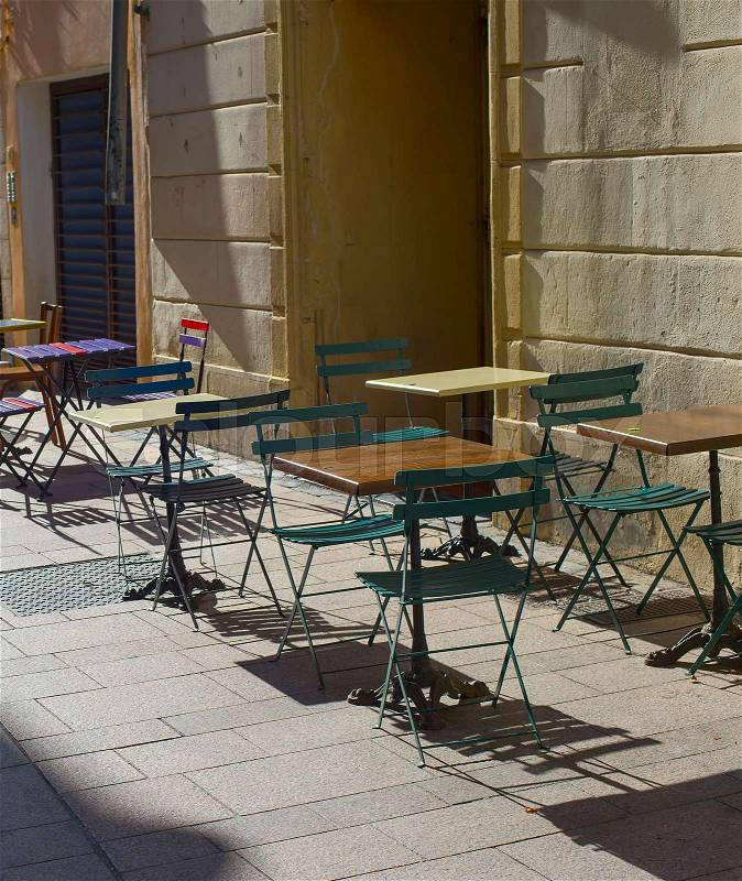 Empty street restaurant on the old town street of Perpignan, France, stock photo