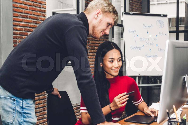 Two business people working and discussing strategy with laptop computer.creative business people planning and brainstorm in modern work loft.Teamwork concept, stock photo