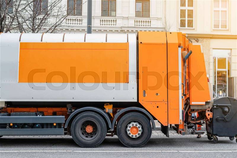 Garbage disposal lorry at city street. Waste dump truck on town road. Municipal and urban services. Waste management, disposal and recycling. Mock-up empty space. ..., stock photo
