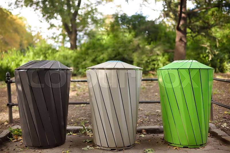 Trash cans for separate recycling garbage in public park. Ecology, recycling and protection of nature concepts, stock photo