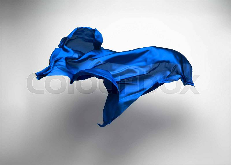 Abstract piece of blue fabric flying, high-speed studio shot, stock photo